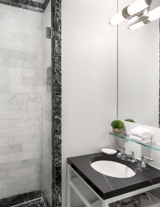 White brick marble shower with black marble trim at the Maison 140 hotel in Beverly hills.